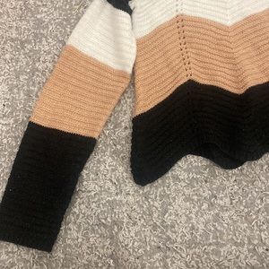 Black,white,and pink sweater size large.